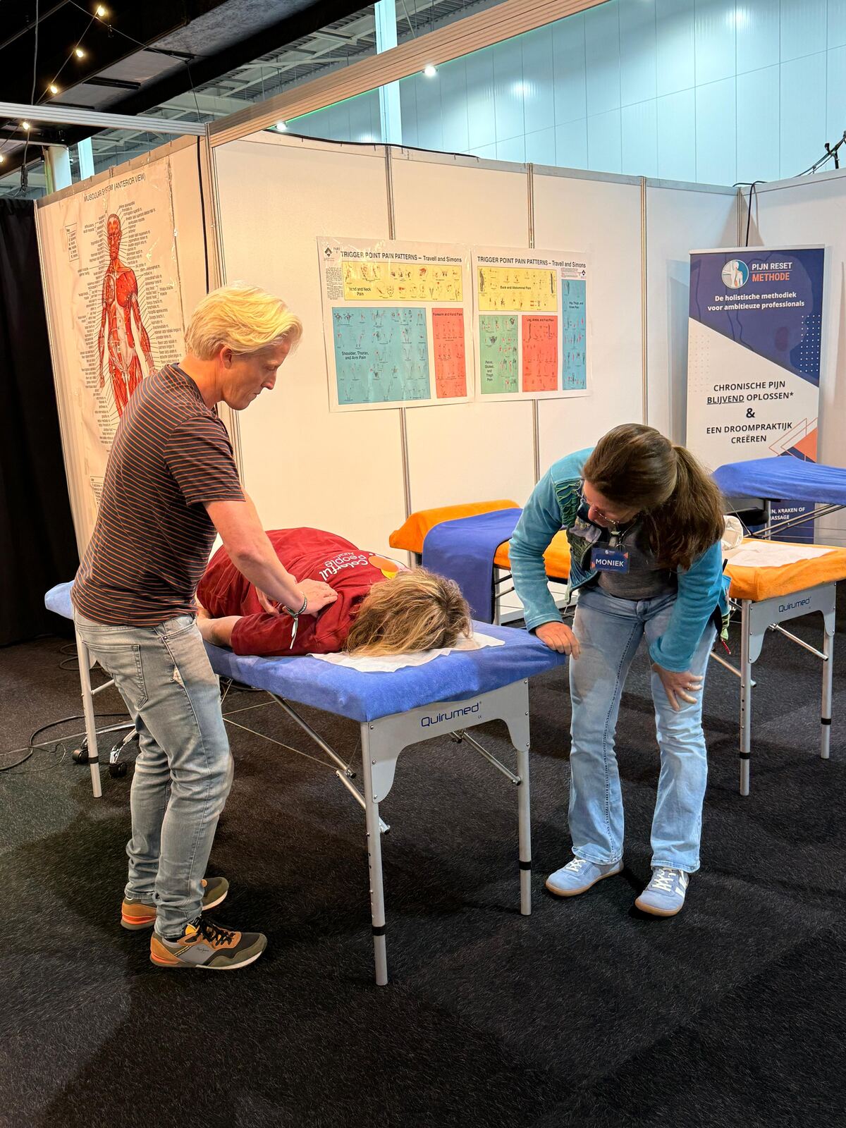 René van Tiggelen past een techniek toe bij een beursbezoeker tijdens de Complementaire ZorgVakbeurs